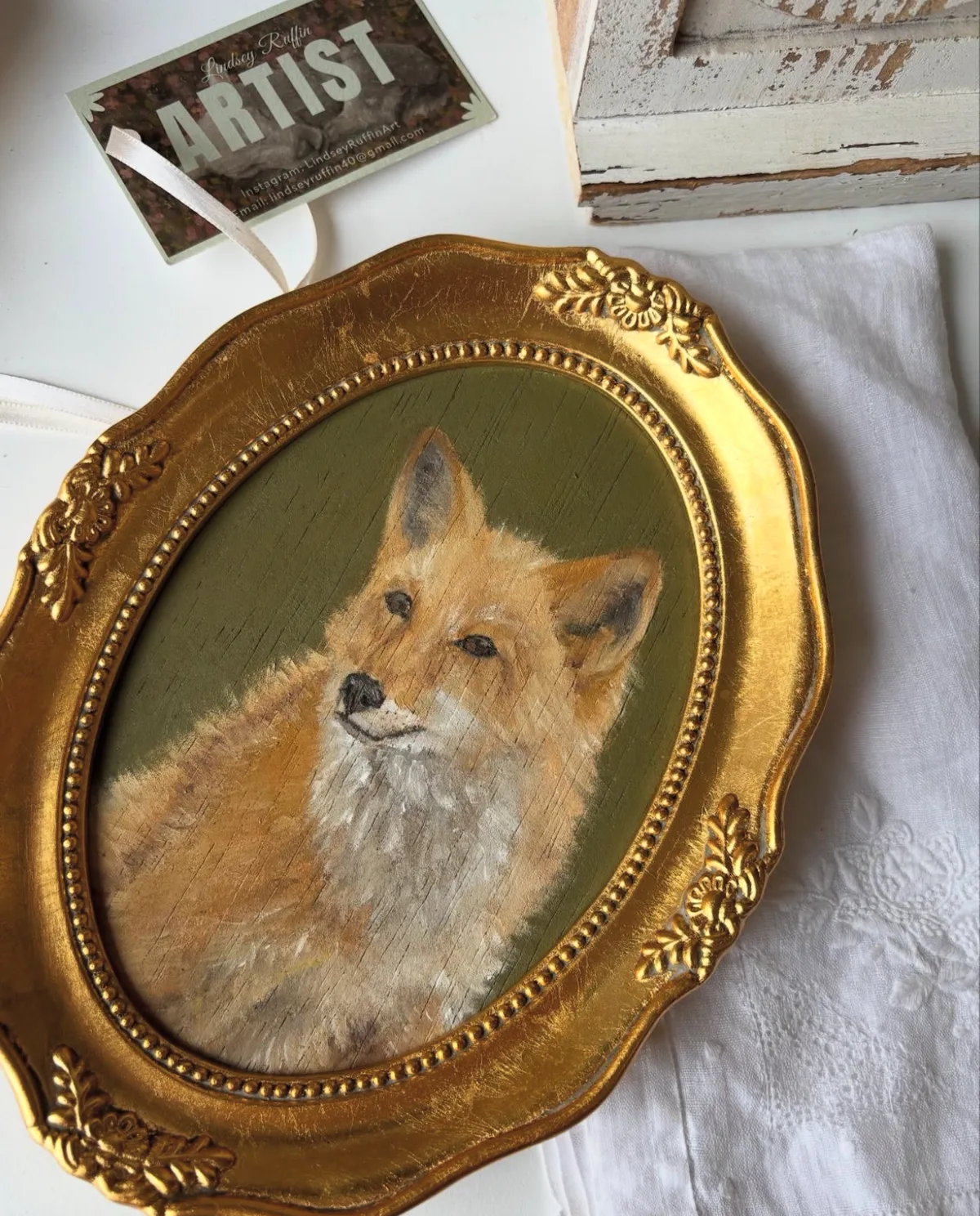 A painted fox presented in an ornate gold oval frame